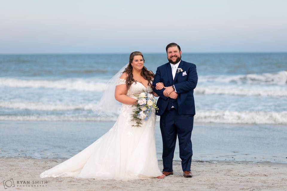 Bride and groom by the ocean