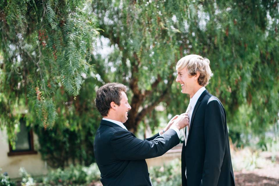A handsome groom and his best man in a last minute pep talk.