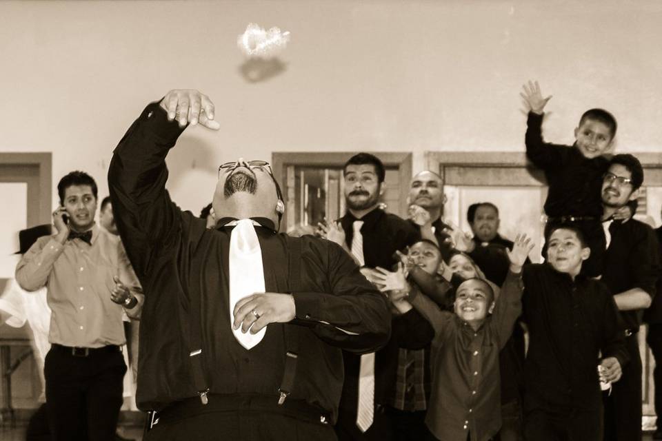 The groom tossing the garter