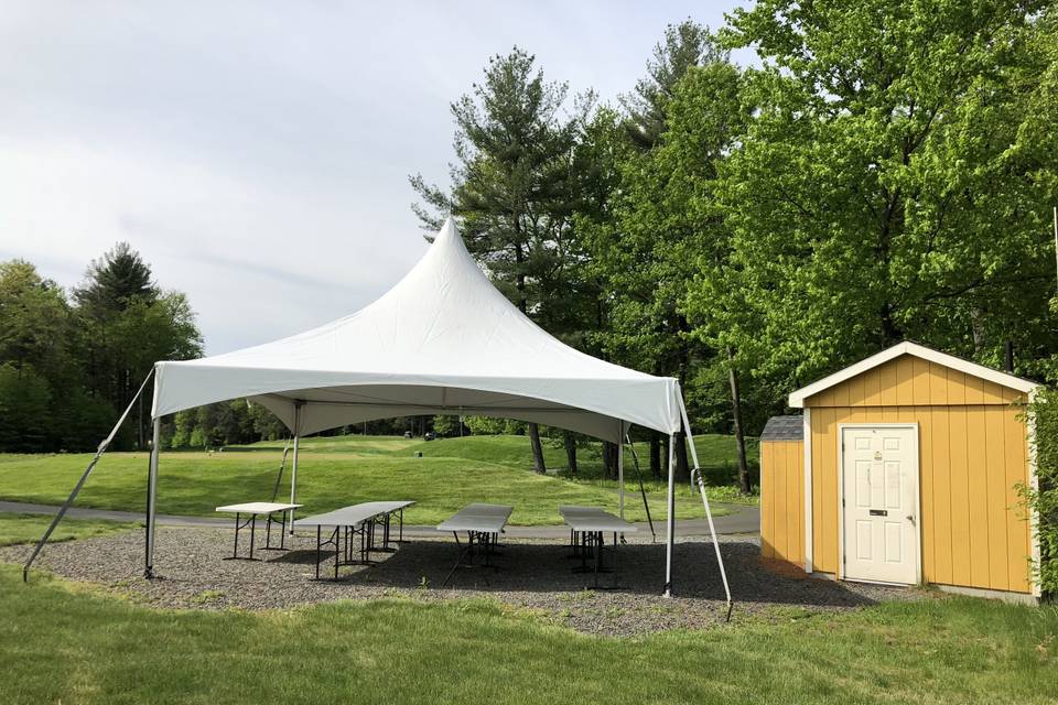 Tent set-up next to a outdoor bathroom