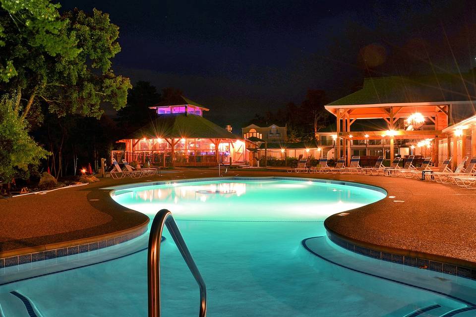 The Pool area at night with the beach bar in the distance.