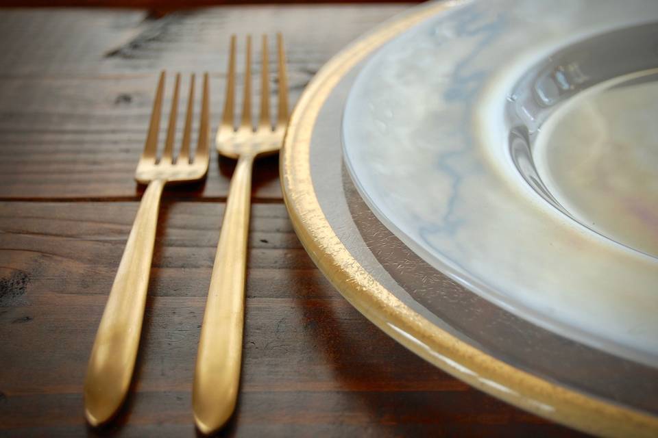 Velo brushed gold flatware, gold rimmed glass charger, luster plates