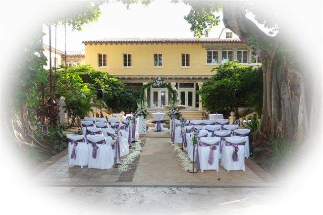 Addison Banquet Hall courtyard, Boca Raton. Our set up with arch with fresh flowers , shephard hooks & lanterns, pedestals , fresh petals in aisle