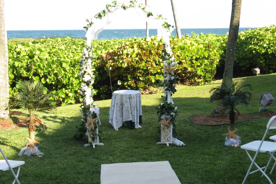 Seashell theme on pedestals & arch at Sea Watch restaurant garden overlooking ocean