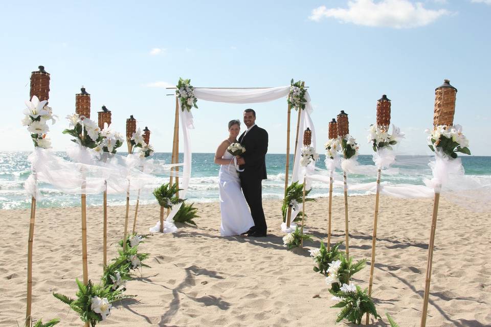 Wedding white theme onTiki torches & arch