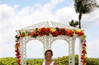 Tropical silk flowers on gazebo & pedestals. Sea Watch garden overlooking ocean.