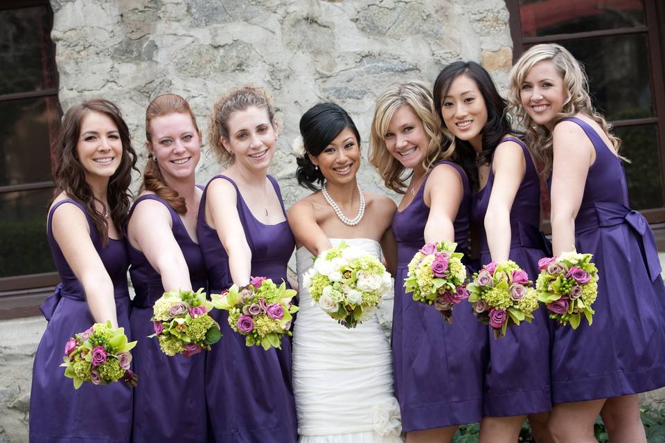 Bridal Bouquet of Mini Hydrangea, Roses, Ranunculus, Cymbidium Orchids, Roses, and Spray Roses.  Bridesmaids' Bouquets of Mini Hydrangea, Cymbidium Orchids, and Roses