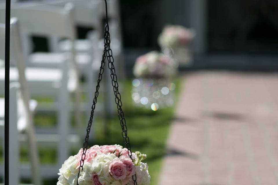 Aisle Decor of hanging crystal chandeliers with Hydrangea and Spray Roses