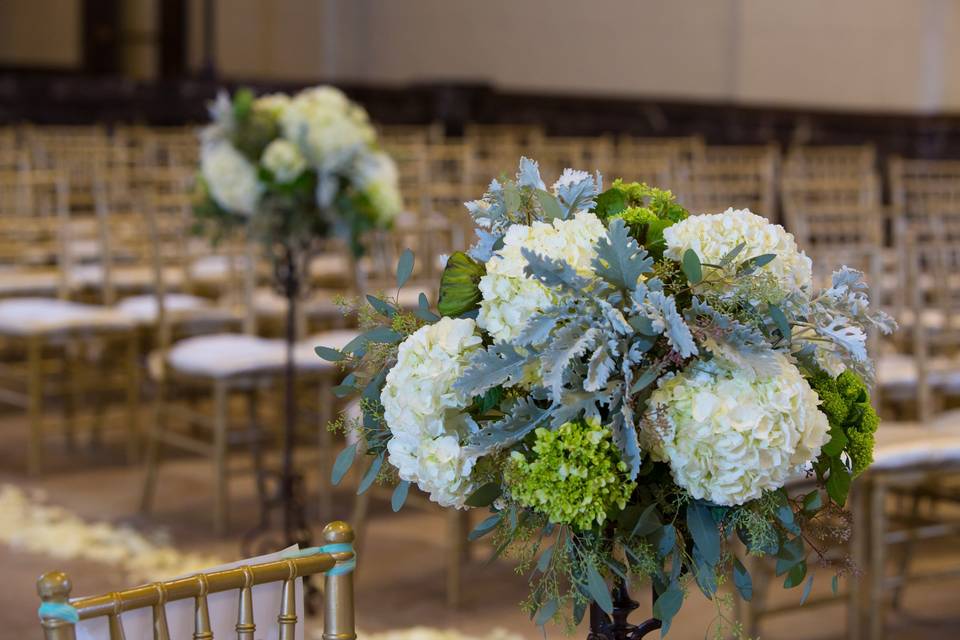 Elevated Centerpieces used at Aisle Decor.  Hydrangea, Lotus Pods, Dusty Miller, Seeded Eucalyptus