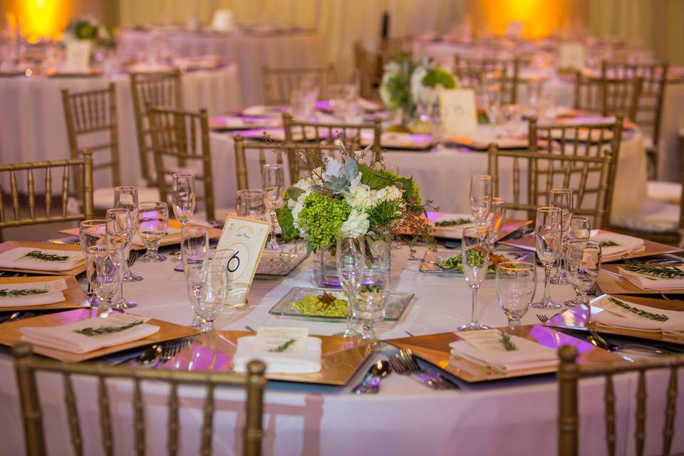 Centerpieces of Hydrangea, Dusty Miller, Eucalyptus, Lotus Pods, Succulents, and Rosemary