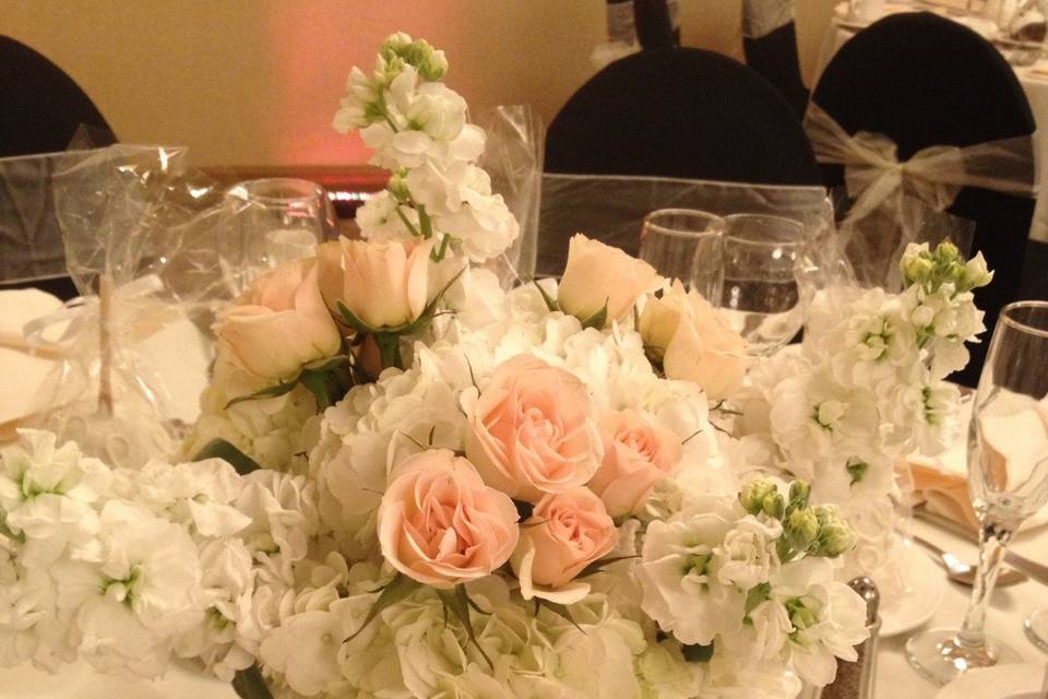 Centerpiece of White Hydrangea, Stock, and Blush Pink Spray Roses