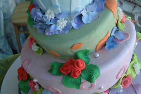 Fondant covered topsy layers with sugarpaste & fondant flowers.