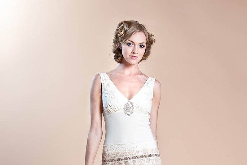 HAVILAND <br>Ivory cotton and lace with tulle overskirt sheath wedding dress accented with jacquard and pearl trim details.