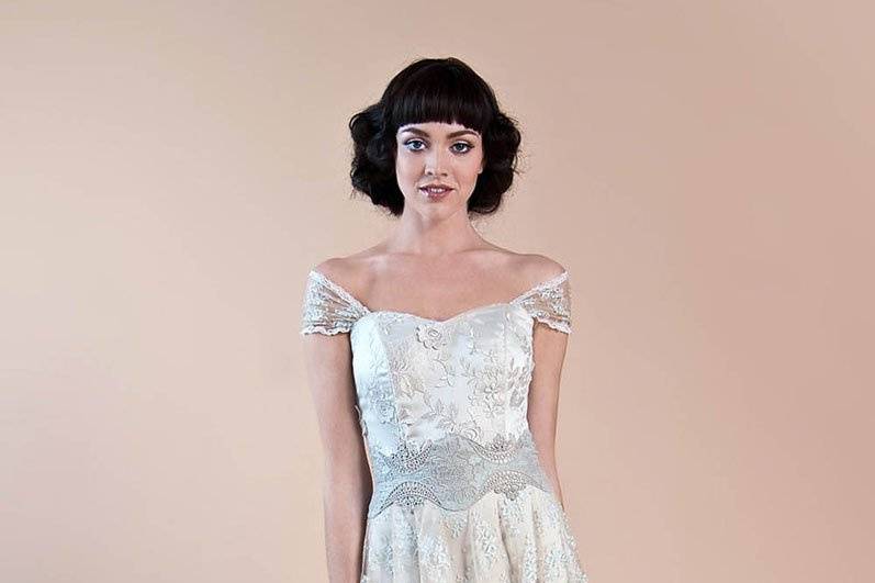 HAZEL <br>Floral embroidered sweetheart neckline wedding dress over luxurious platinum silk charmeuse with vintage lace shawl and overskirt in powder blue accented with guipure embroidered waist detail.
