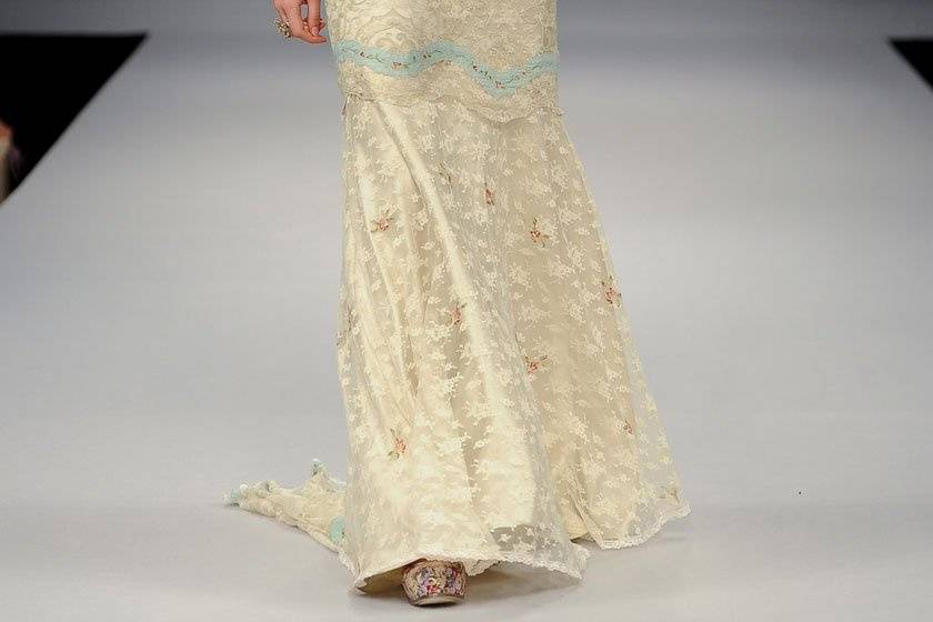 OOH LA LA <br>Antique blue lace embroidery with tiny pink roses adorning the sheath silhouette with sheer back and delicate lace cap sleeves.