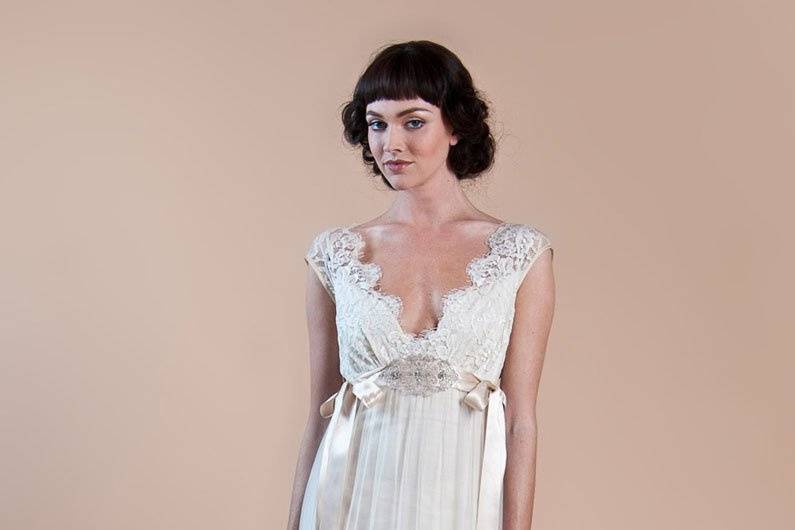 QUEEN ANNE'S LACE <br>Ivory cotton and tulle Empire silhouette with English lace bodice and hem, silk ribbon ties, and beaded applique.