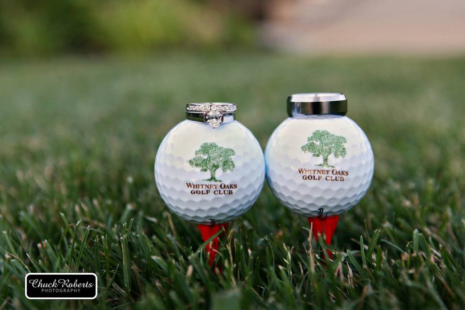 Couple's wedding rings on a golf ball