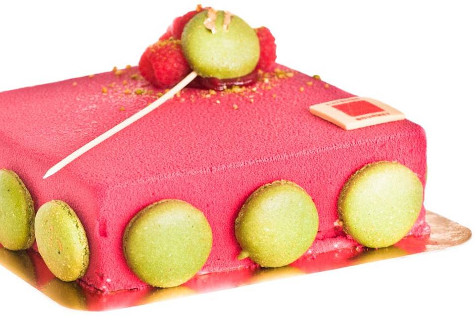 One of the Best - The RougeMascarpone mousse folded with raspberry bits and vanilla, filled with a layer of creamy raspberry and cherry cream over a pistachio sponge cake