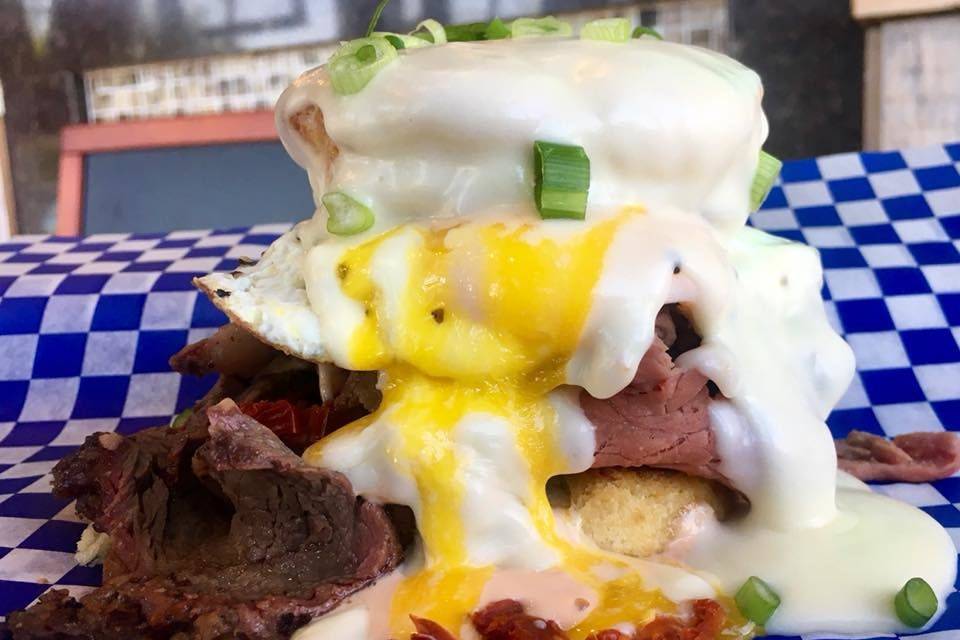 Rise & Prime! Smoked Prime Rib, Biscuit, Special Sauce, Swiss Cheese Sauce, Sun Dried Tomato, Green Onion, Egg, and a Side of Party Potatoes.
