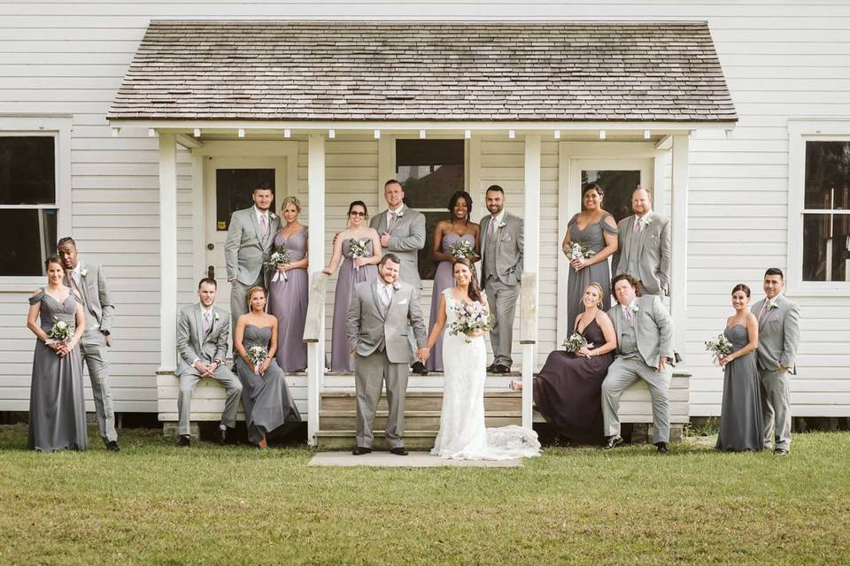 Newlyweds and their guests outside the house