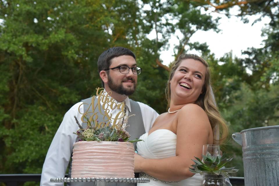 Groom and bride by the wedding cake