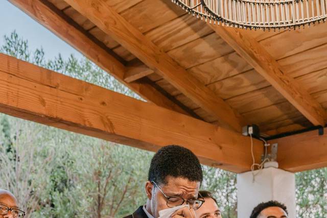 Groom crying holding napkin