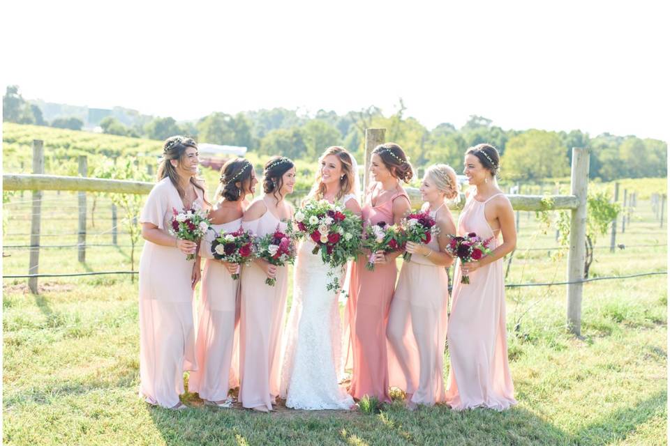 Bride poses with her bridesmaids