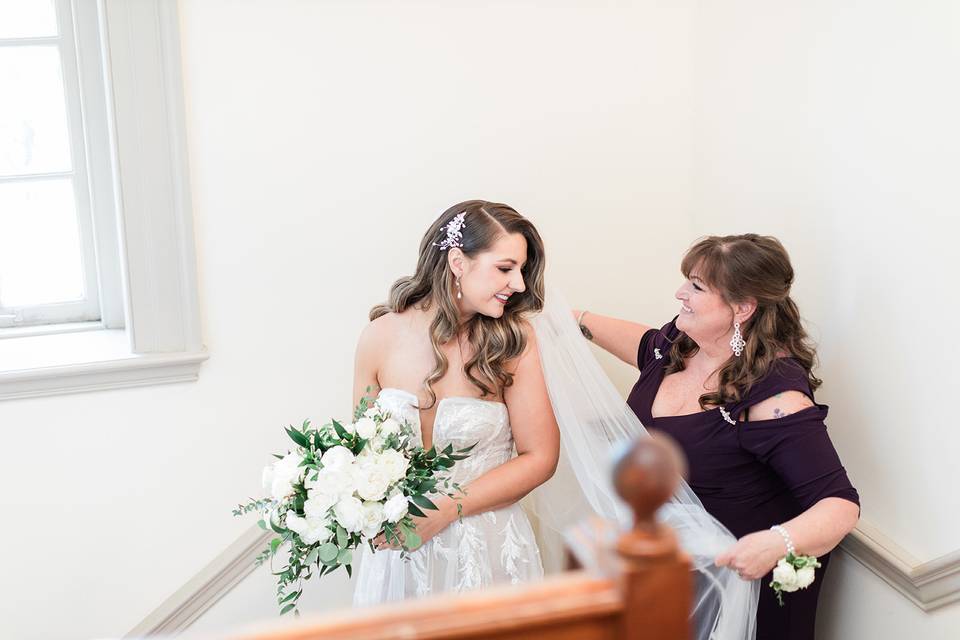 Mother helps with veil