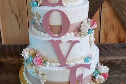 Buttercream frosted  cake with fondant and white chocolate accents - $2.50 per serving ($2.75 for 5+ tiers)