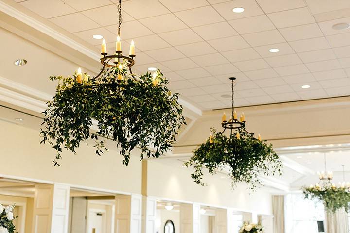 Greenery-draped chandeliers