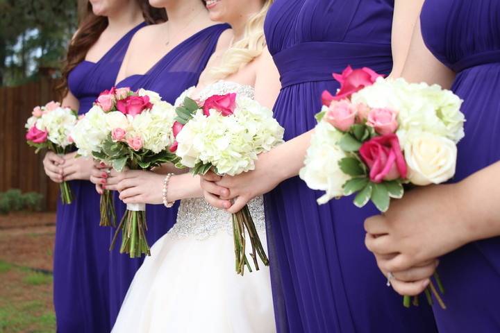 The bride with her bridesmaids holding the  bouquet