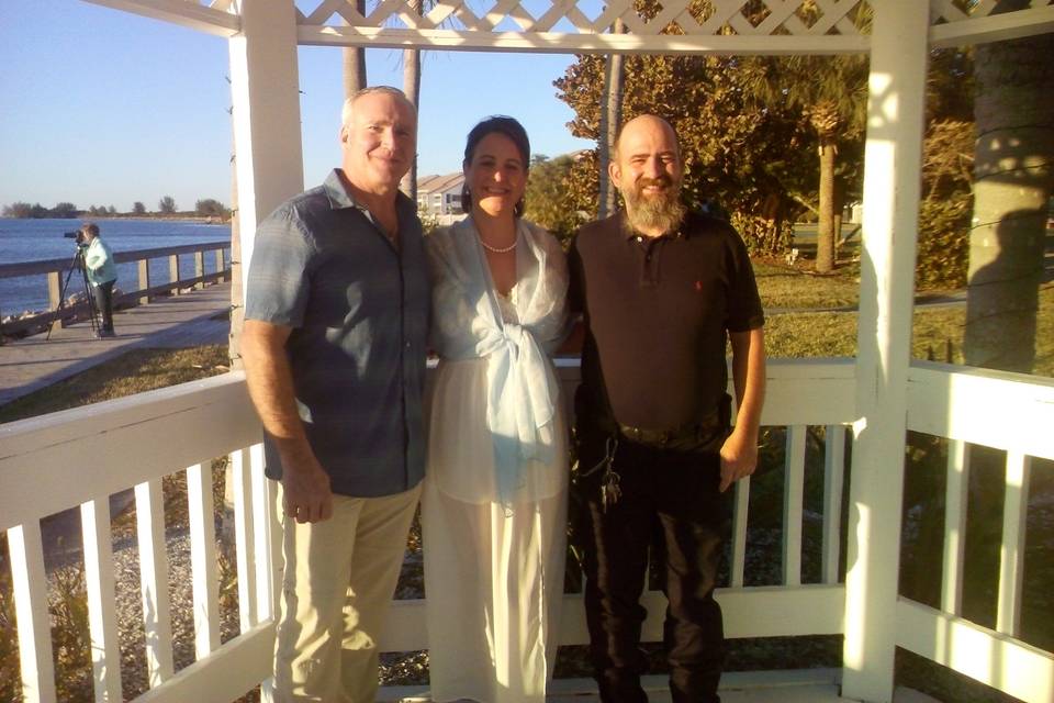 Reverend and the newlyweds at the gazebo