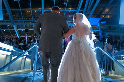 entering their wedding reception at the Akron Art Museum
