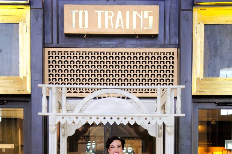 Bride standing under arch