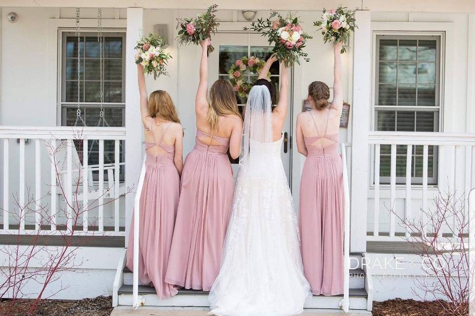Bride and bridesmaid reaching for flowers