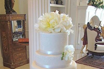Simply Elegant 5 tier Wedding Cake with white satin ribbon and live flowers.