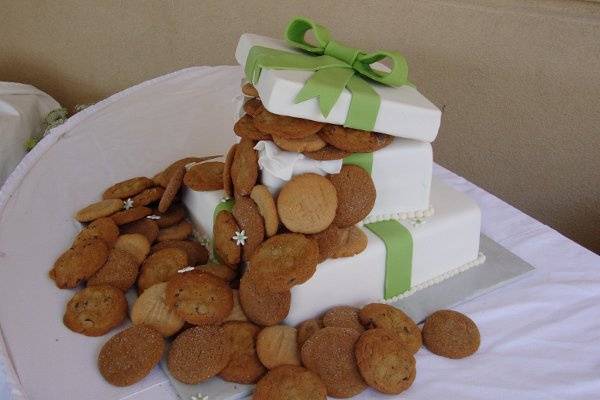 Out of the Box Wedding Cake.  Square fondant covered cake with a variety of cookies cascading out of the box and down the edges of the cake.