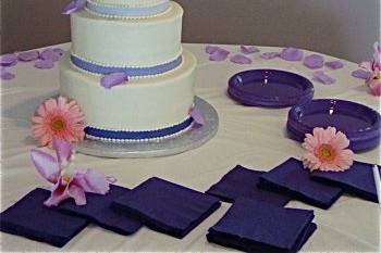 Purple Roses.  3 tier buttercream Wedding Cake with purple fondant ribbon and live purple roses.