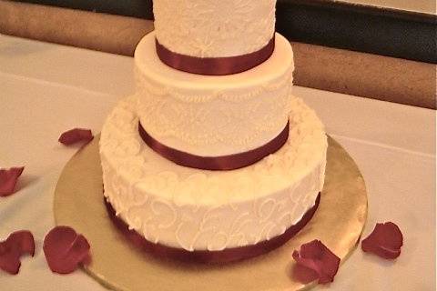 Garnet and gold FSU Bride and Groom.  Garnet ribbon on a buttercream cake.