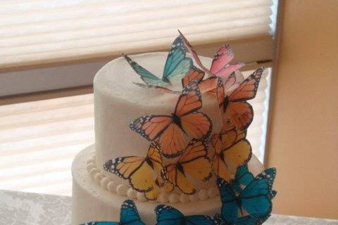 Edible rainbow butterfly wedding cake.