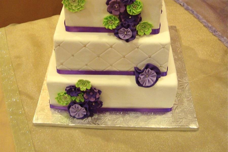 American Gypsy.  Quilted pattern with silver dragees.  Purple and green vintage styled flowers.  Modern color vintage wedding cake.