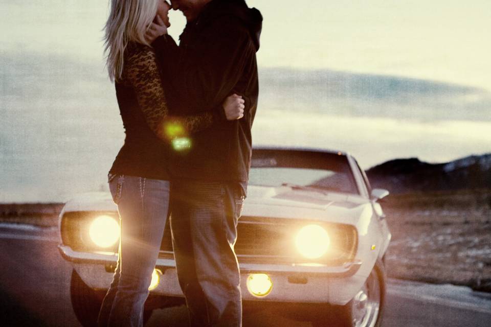 Couple standing by car