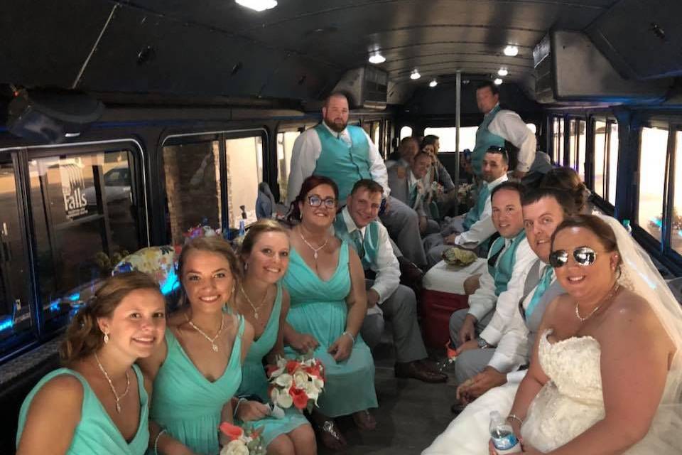 Bridesmaids and groomsmen inside the bus