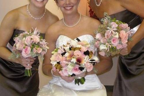 bridal bouquet with white sweetpeas, Polar Star roses, white peonies, white French tulips, green parrot tulips, bunny tail grass, succulents, scented geranium, Green Fashion roses, Star Blush spray roses, a linen and ivory lace stem wrap, and white eyelash feathers