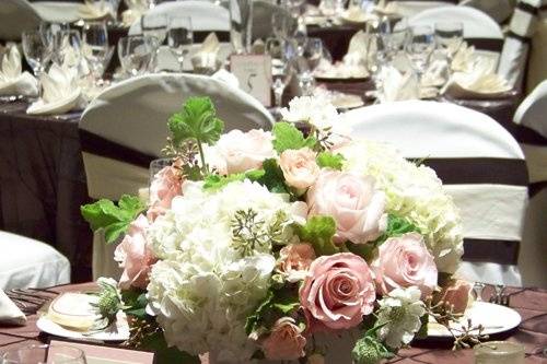 low centerpiece with Charming Unique and Sweet Akito roses, Dali spray roses, hydrangea, scabiosa, scented geranium, and seeded eucalyptus