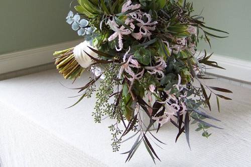 hand-tied cascade with blush nerine lilies, agonis, baby blue eucalyptus, seeded eucalyptus, and green leucadendron
