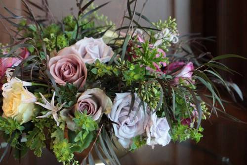 centerpieces with Amnesia roses, Maritim roses, Cream Prophyta roses, Little Silver spray roses, blush nerine lilies, agonis, bupleurum, seeded eucalyptus and birch branches in a gold footed bowl
