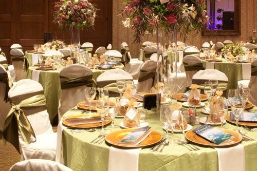 tall centerpieces with Amnesia roses, Maritim roses, Cream Prophyta roses, Little Silver spray roses, blush nerine lilies, agonis, bupleurum, and seeded eucalyptus on 32 inch cylinder vases