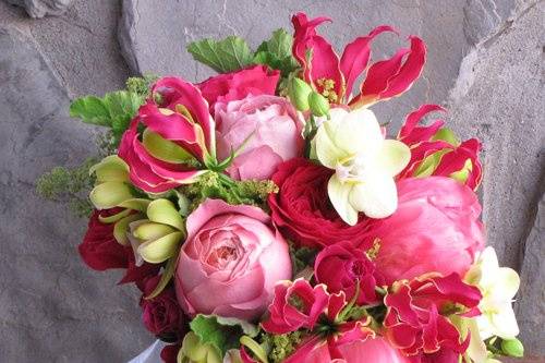 bridal bouquet with David Austin “Darcey” garden roses, Hot Majolika spray roses, gloriosa lilies, Coral Charm peonies, Romantic Antike garden roses, green mini cymbidium orchids, green Phalaenopsis orchids, alchemilla and scented geranium