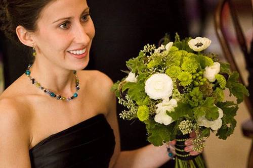 bridesmaid bouquet with black privet berries, Uluhe fern curls, black and white anemones, white ranunculus, stellata pods, seeded eucalyptus, green hydrangea, Kermit button poms, Green Condor hypericum berries, green wheat and scented geranium